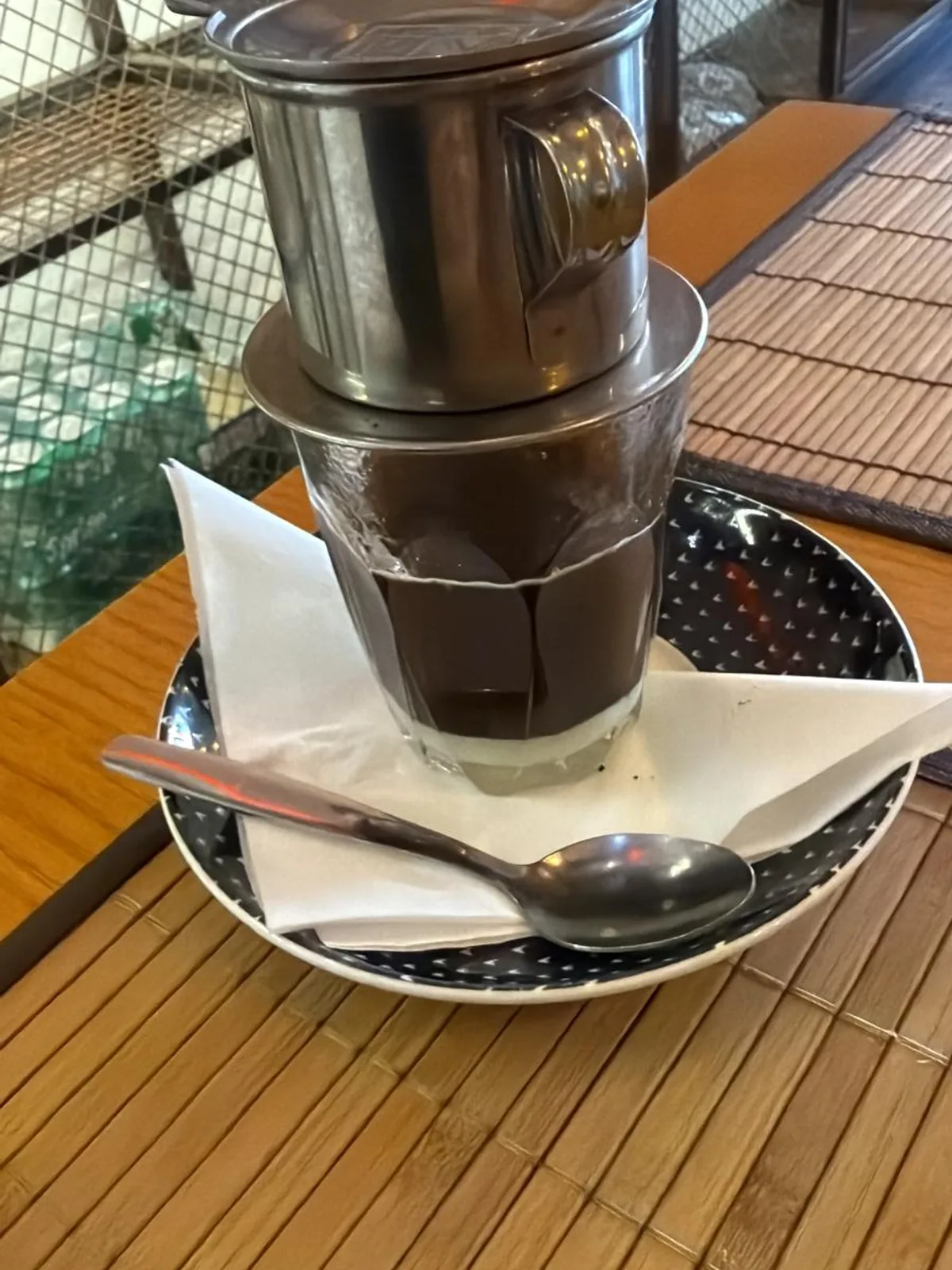 A Vietnamese drip coffee on a café table